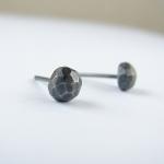 Small faceted studs . Black..